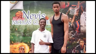 Brooklyn Nets center Nicolas Claxton (r) with student during his basketball clinic on Nevis.webp