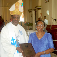 Eileen Grey Receives Award From Bishop Gabriel Malzaire