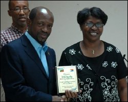 PM Douglas Accepts Plaque From Frances Henry