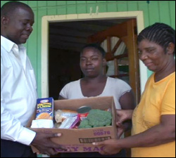 Minister Hector Hands Over Donated Food To Imelda Clarke