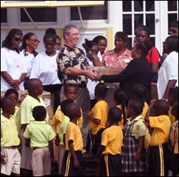 Nisbet Planation GM Jamie Holmes Hands Over Books To Mrs. Sonita Daniel