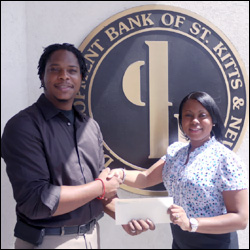 Pierre Liburd Accepts Check From Danienne Brin