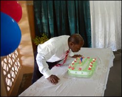 Prime Minister Douglas Blows Out Candles