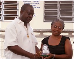 Valerie James Receives Plaque From Robelto Hector